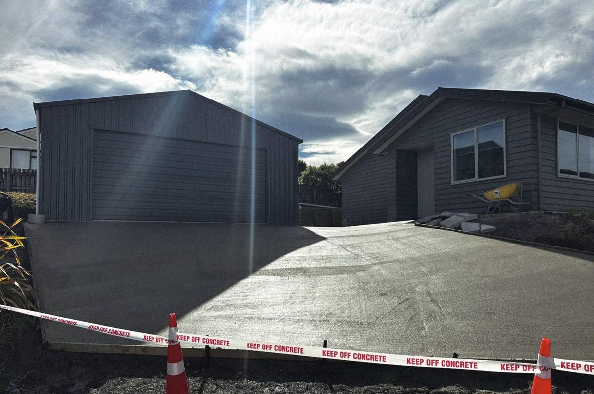 After: a new concrete driveway in front of the garage and house